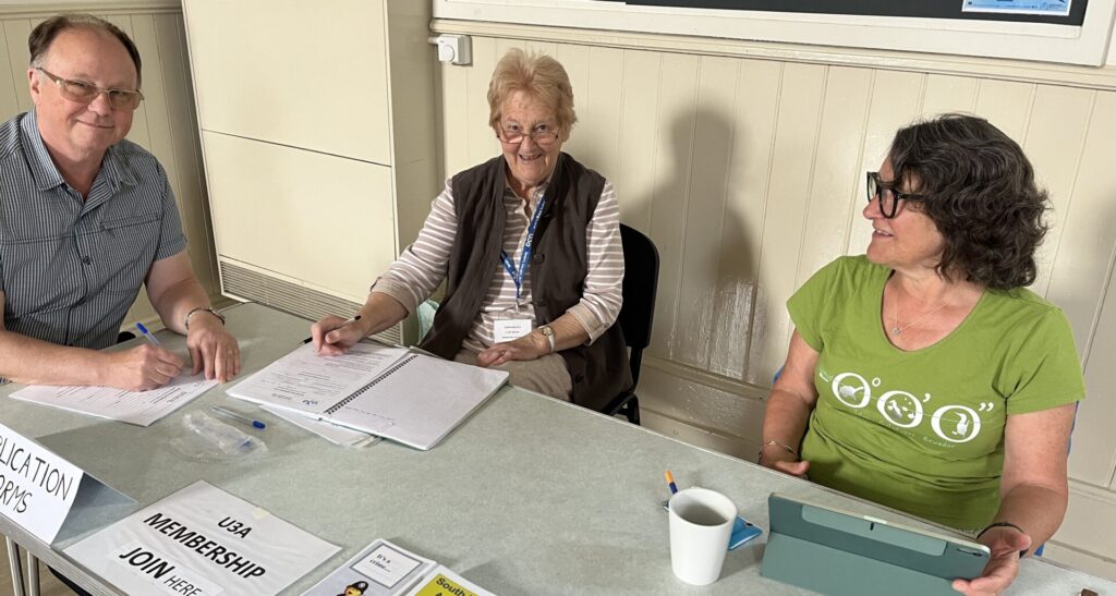 Three people at a desk ready to take membership subscription renewals